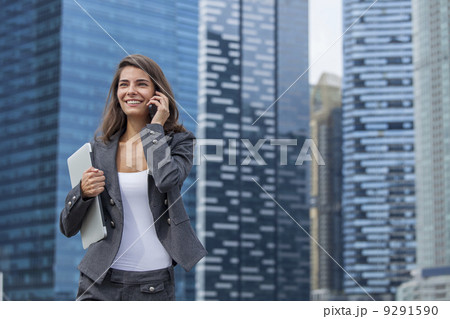 Caucasia lady in jacket carrying a laptop computer 9291590