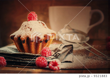 Fruitcake Decorated with Raspberry and icing sugar at the wooden Fruitcake Decorated with Raspberry and icing sugar at the wooden 9321883