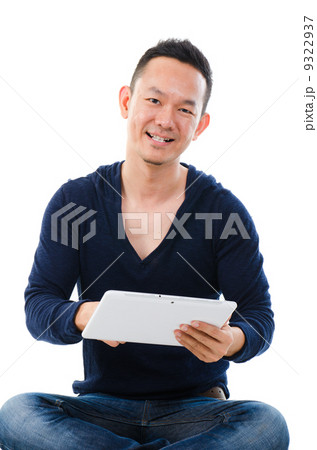 Asian man holding tablet computer isolated on white background. Asian man holding tablet computer isolated on white background. 9322937