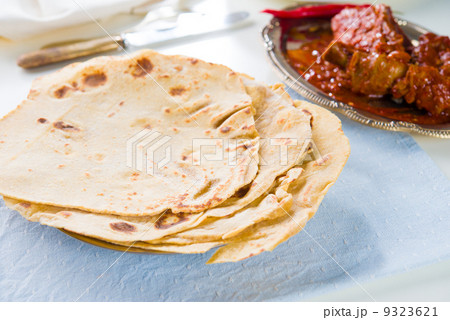 Chapatti roti and Indian food on dining table. Chapatti roti and Indian food on dining table. 9323621