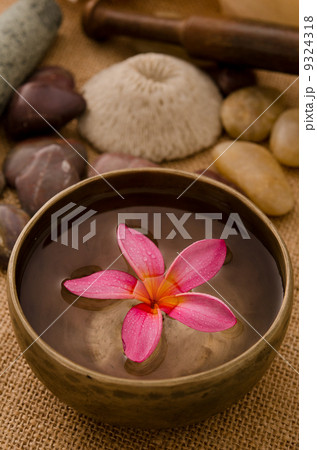 tropical spa setup with frangipani flower 9324318