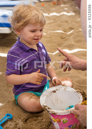 Little toddler boy playing with sand and toy Little toddler boy playing with sand and toy 9328886