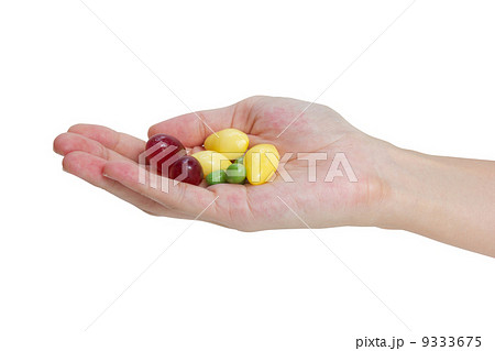 Fresh grapes, ginkgo and peas in hand isolated on white backgrou 9333675
