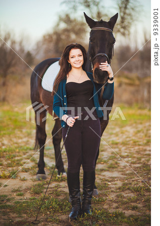 Young woman with a horse on nature 9339001