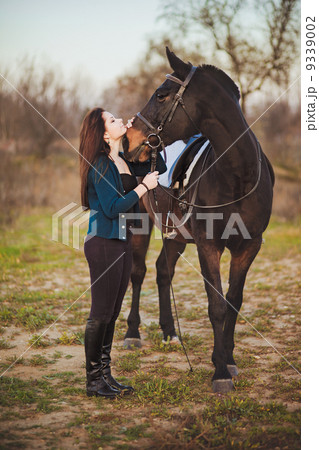 Young woman with a horse on nature 9339002