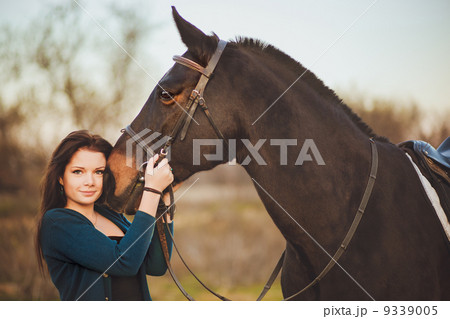 Young woman with a horse on nature 9339005