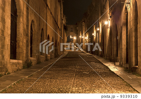Medieval Avenue of the Knights at night, a cobblestone street in Rhodes Citadel , Greece Medieval Avenue of the Knights at night, a cobblestone street in Rhodes Citadel , Greece 9339310