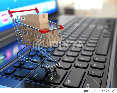 E-commerce. Shopping cart with cardboard boxes on laptop. 9342312