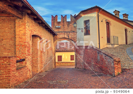 Cobbled street and red brick medieval walls. 9349064