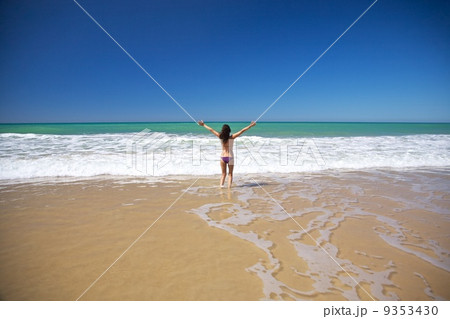 woman happy at seashore in Conil beach 9353430