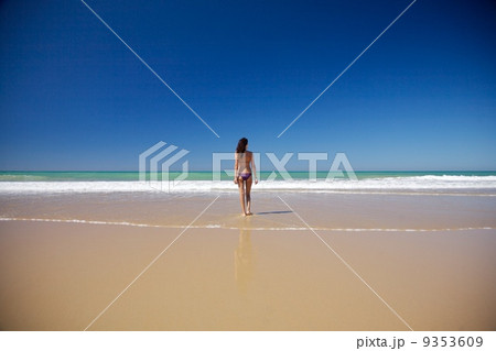 woman walking at seashore in Conil beach 9353609