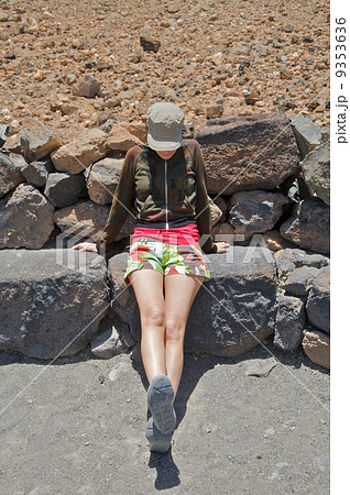 woman sitting on stone 9353636