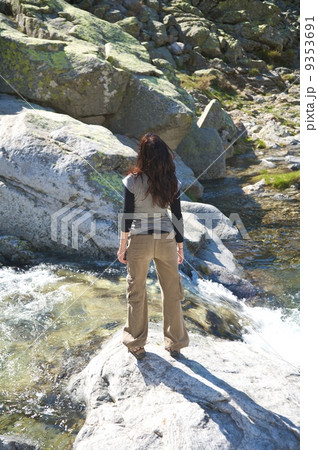 woman stand up next small waterfall woman stand up next small waterfall 9353691