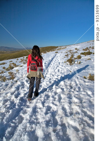 female trekking on snow path 9353699