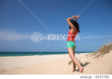 red shirt woman dancing at the beach 9353780