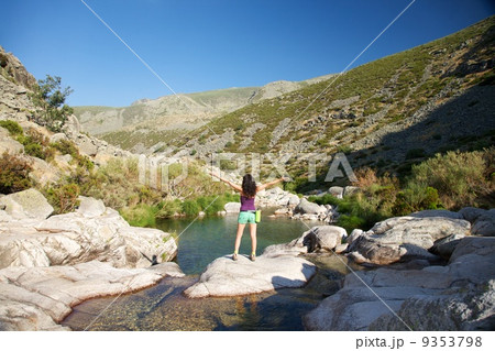 winner woman on a rock watching river winner woman on a rock watching river 9353798