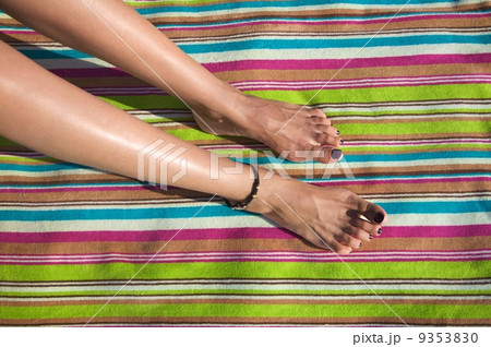 woman legs on striped towel 9353830