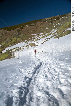 trekking alone on snow path 9353953