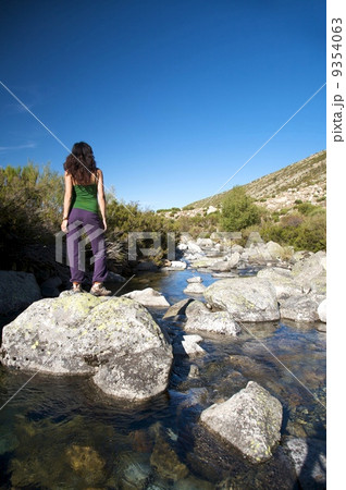 rock in the river with woman 9354063