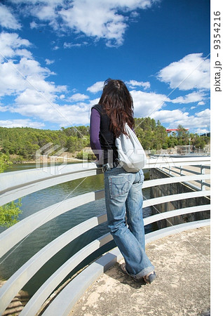 woman at banisters of a dam 9354216