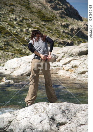 woman brown trousers placing belt 9354243