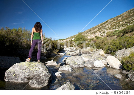 woman watching river rock 9354284