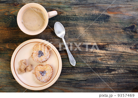 Coffee and cookies in the shape of heart. 9357469