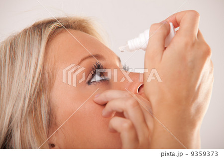 woman`s eye and eyedropper with waterdrop on tip 9359373