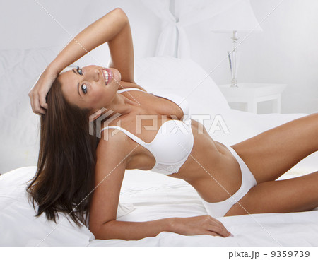 young beautiful woman on bed 9359739