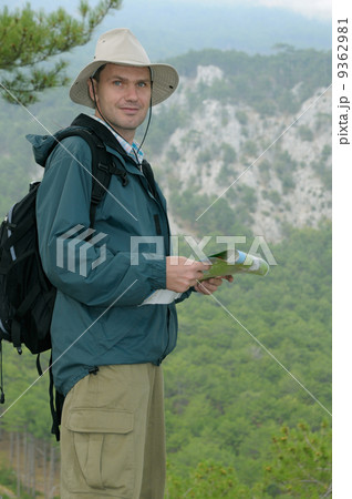 Hiker looking at a map while out trekking Hiker looking at a map while out trekking 9362981