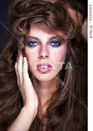 Portrait of a young sexy woman with a mass of long hair 9364065