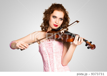 young attractive woman in pink corset on a violin young attractive woman in pink corset on a violin 9373731