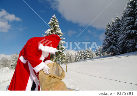 Santa Claus is looking in his bag 9375891