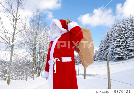 Santa Claus walking along a path 9376421