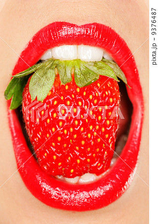 strawberry in a mouth with red lips strawberry in a mouth with red lips 9376487