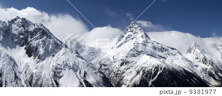 Panorama mountains in clouds. View from the ski slope. 9381977