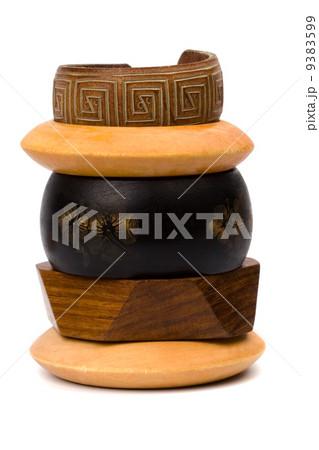 stack of wooden and leather bracelets 9383599