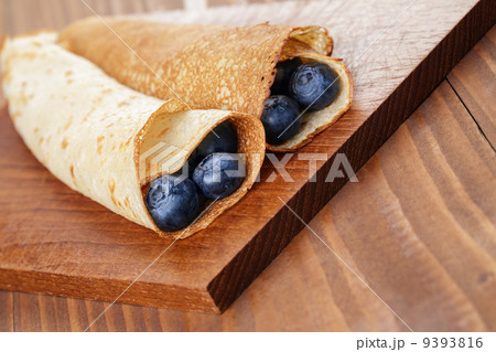 homemade blinis or crepes with blueberries 9393816