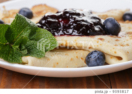 homemade blinis or crepes with blueberries and jam 9393817