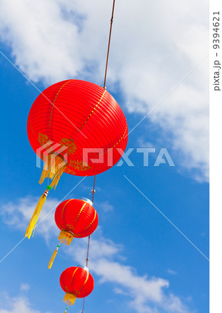 Red Chinese Paper Lanterns against a Blue Sky 9394621