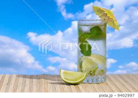 Mojito cocktail against blue sky Mojito cocktail against blue sky 9402997
