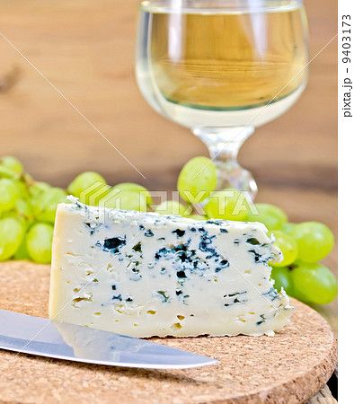 Cheese blue on board with wine and grapes 9403173