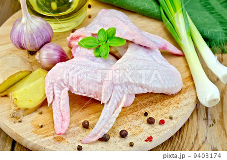 Chicken wings with garlic on a board 9403174