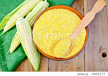 Corn grits with corn cobs on a board 9403177