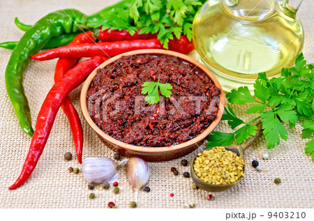 Adjika with hot pepper and oil on burlap 9403210