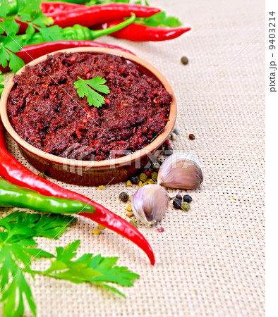 Adjika with hot pepper and garlic on burlap 9403214