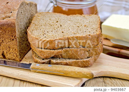 Rye homemade bread stacked with honey and knife Rye homemade bread stacked with honey and knife 9403667