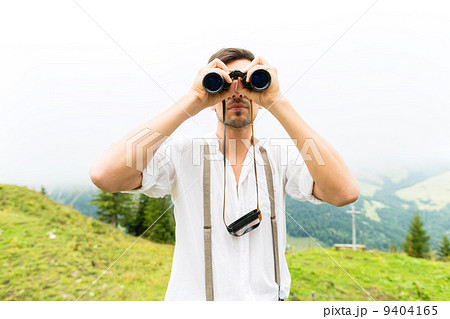 Alps - Man on mountains with field glasses 9404165
