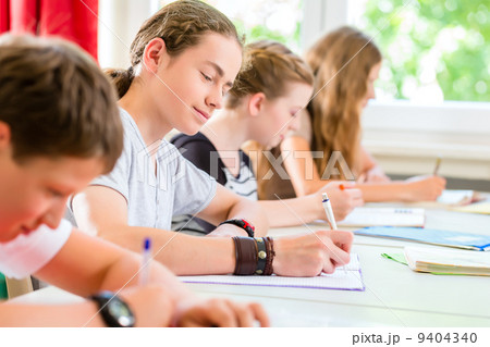 Students writing a test in school concentrating 9404340