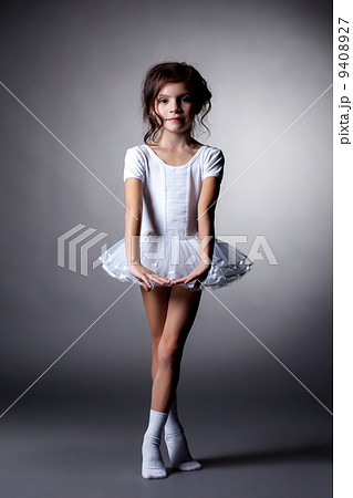 Elegant dark-haired gymnast posing in studio 9408927
